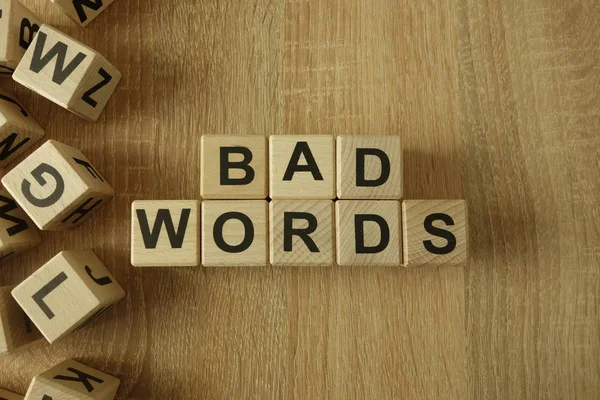 Bad words text from wooden blocks on desk