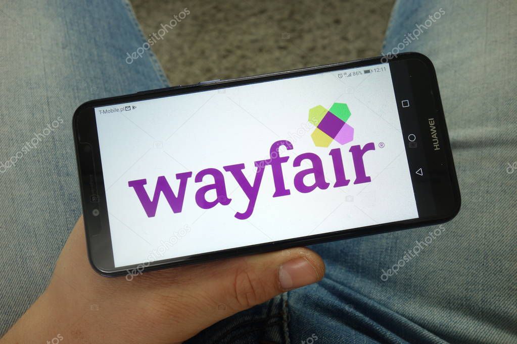 KONSKIE, POLAND - April 13, 2019: Man holding smartphone with Wayfair company logo