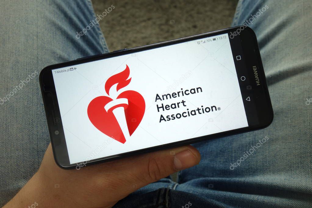 KONSKIE, POLAND - April 13, 2019: Man holding smartphone with American Heart Association (AHA) logo