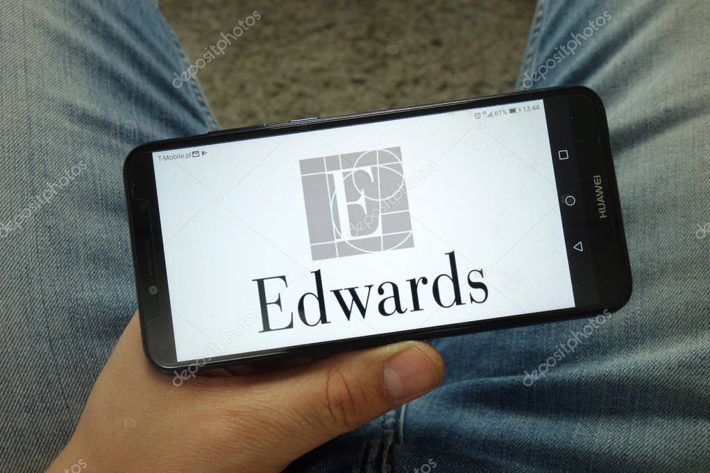 KONSKIE, POLAND - April 13, 2019: Man holding smartphone with Edwards Lifesciences company logo