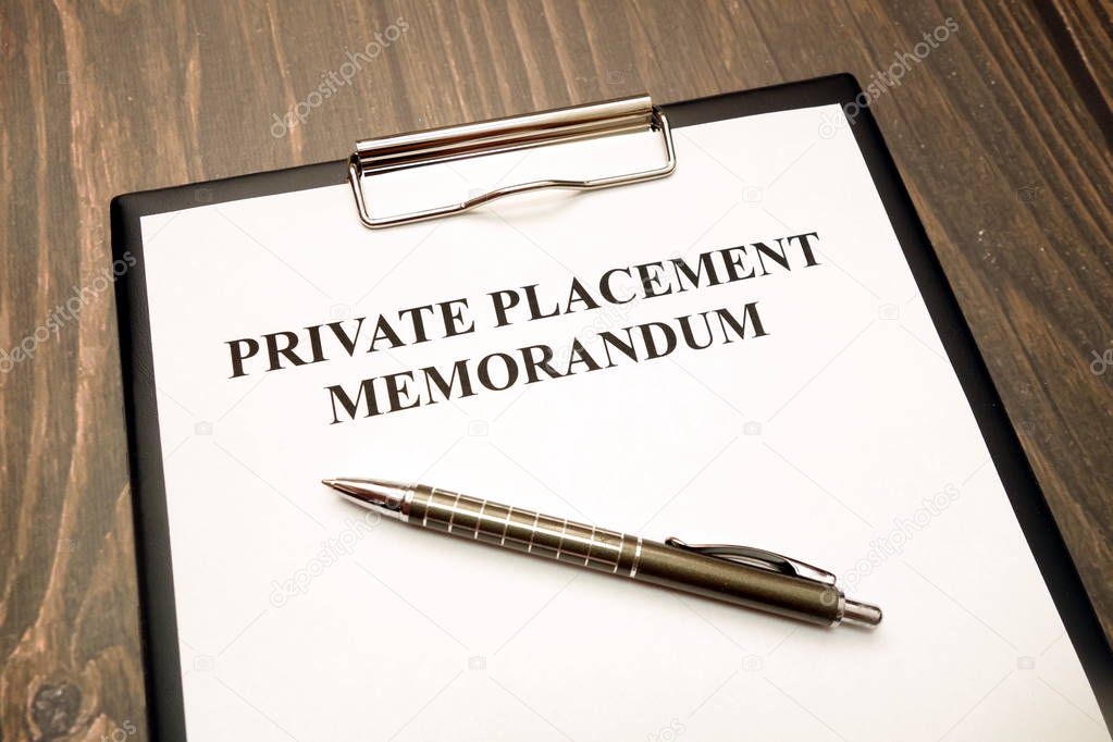 Private placement memorandum document with pen on desk