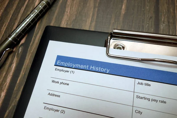 Employment history document, job application form with pen