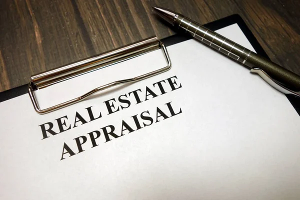 Clipboard with real estate appraisal mockup and pen on desk