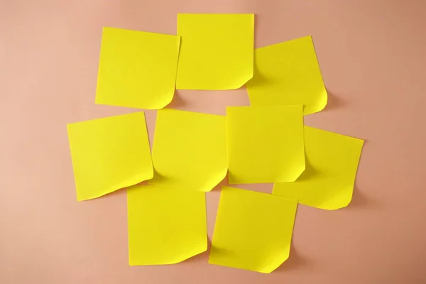 Yellow sticky notes with curled corner on pink background, copy space for design