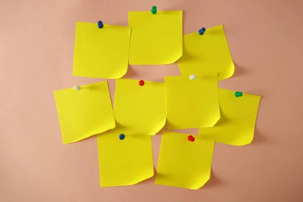 Yellow pinned sticky notes with curled corner on pink background, copy space for design — Stock Photo, Image