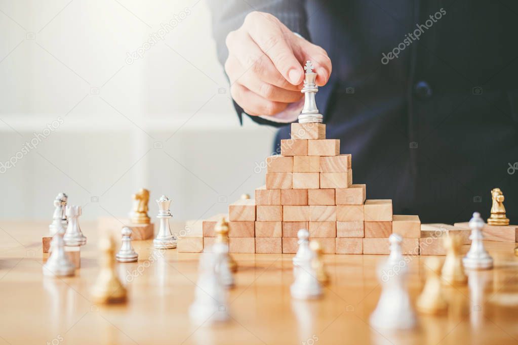 Business leadership concept,chess game on wood game business strategy leader for success