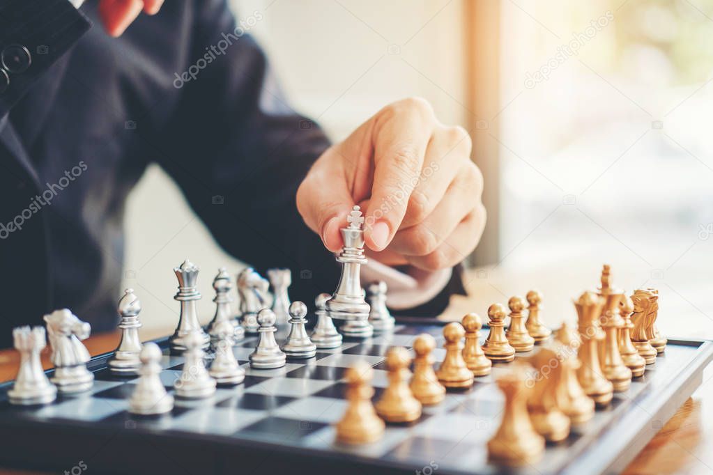 Businessman playing chess game Planning of leading strategy successful business leader concept