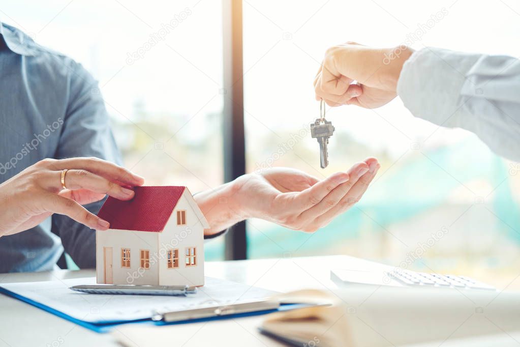 Sale agent giving house to customer and sign agreement contract, Insurance Home concept