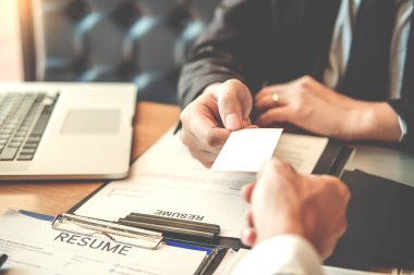 Çalışan genç adam iş mülakat kavramı sırasında üst düzey yönetici için bir kartvizit alışverişi