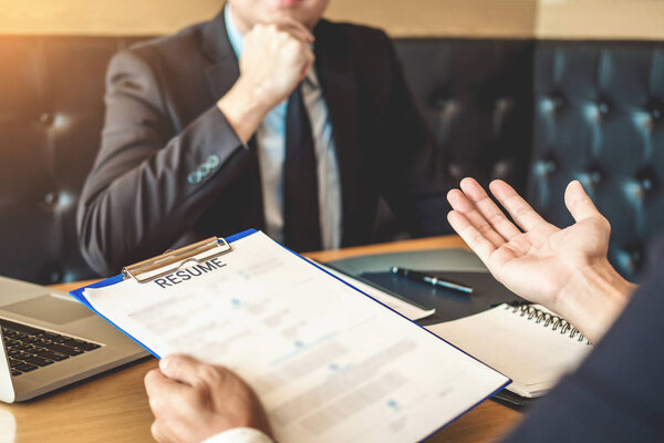 Job interview concept , Senior manager reading a resume during a job interview employee young man meeting Applicant and recruitment