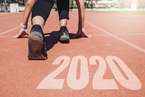 2020 Newyear , Athlete Woman starting on line for start running 