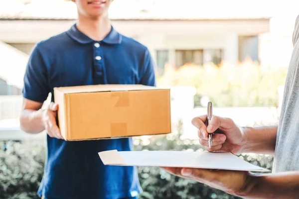 Customer Man signature in clipboard to receive package from prof