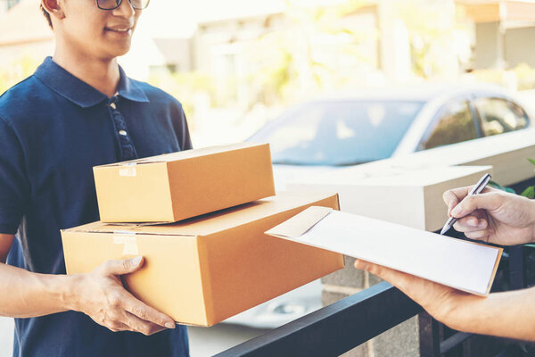 Customer Man signature in clipboard to receive package from prof