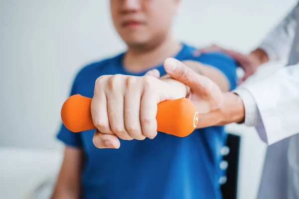 Homem fisioterapeuta dando exercício com tratamento de halteres Abou — Fotografia de Stock