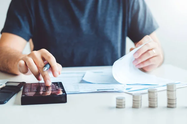 Man using calculator Accounting Calculating Cost Economic bills