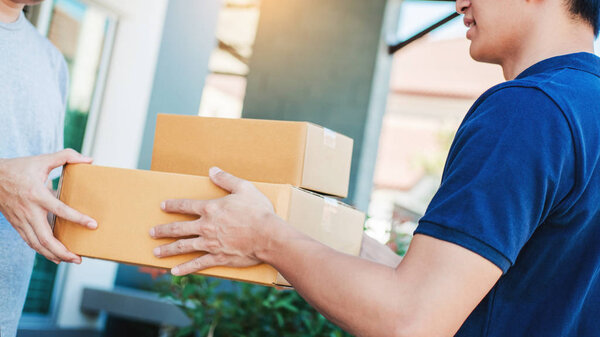 Asian Man hand accepting a delivery boxes from professional deli