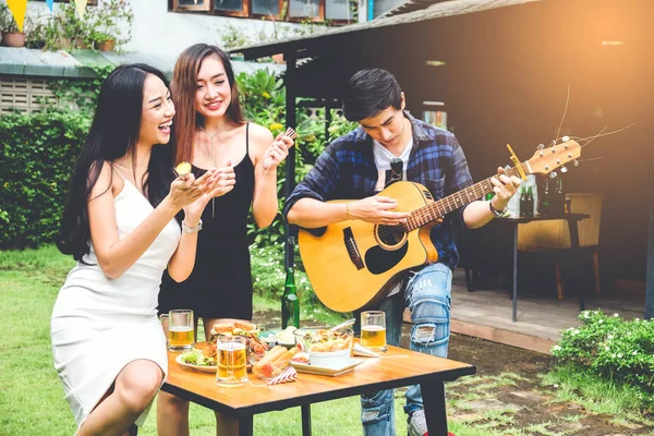 Group of young asian people happy while enjoying garden party an