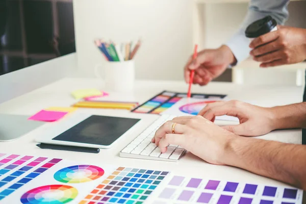 Graphic designer drawing on graphics tablet at workplace Stock Image