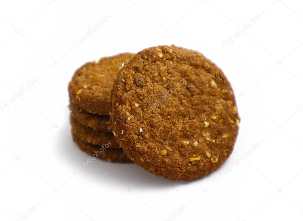 A pile of four healthy brown detailed cereal chocolate cookies.