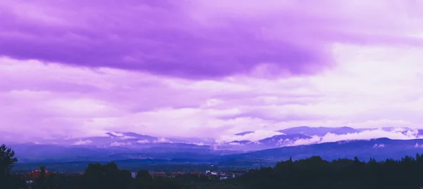 Photo depicting beautiful a foggy mystic mountains. Fog clouds at the pine tree mystical woods, morning. Europe, Bulgaria, mysterious Balkan landscape. Bansko city, Pirin Golf village.