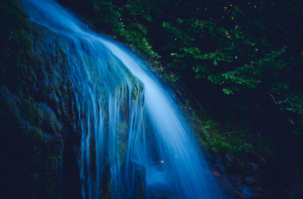 Magic blue waterfall at the forest. Natural fairy waterfall ste