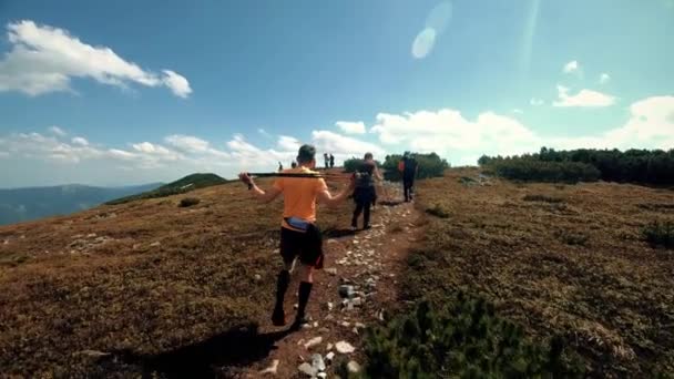 Un grupo de turistas camina por las montañas — Vídeos de Stock