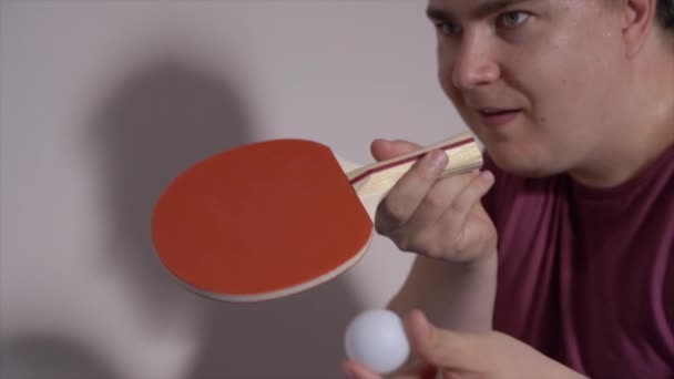 Mladý atletický muž hraje ping-pong, hází míček a dělá nadhoz raketou, zpomaluje. Aktivní zábava nebo příprava na olympijské sportovní soutěže. — Stock video
