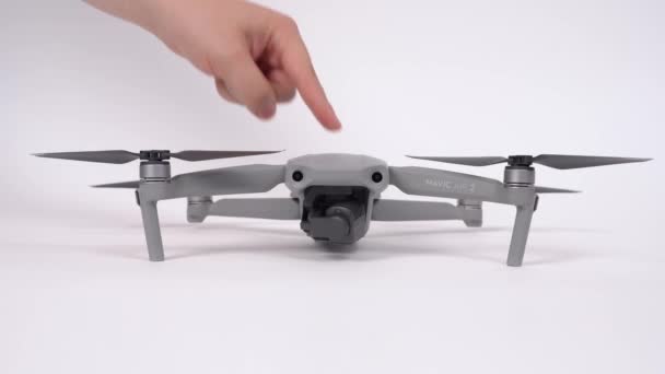 Rostov, Rússia, 23 de julho de 2020: Homem verifica drone Mavic AIR 2 e espalha lâminas antes do voo, pressiona o botão no topo para ligar o gadget, luzes de sinal vêm e a câmera começa a girar, vista frontal . — Vídeo de Stock