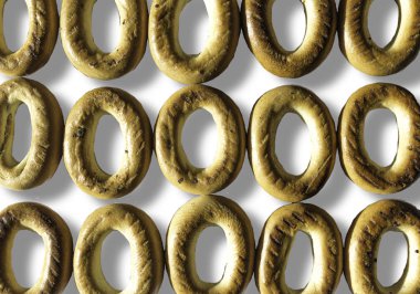 Fotoğraf arka yüzüne simit haşhaş tohumu ile. Simit desen olarak düzenlenmiştir. İzole resmi site mutfak, yiyecek ve gelenekleri hakkında beyaz arka planı için.