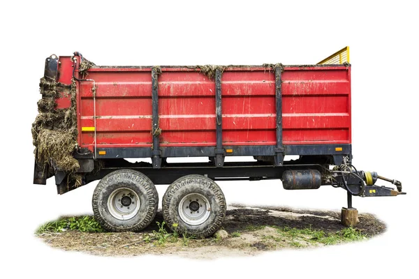 Agricultural machinery on a dairy farm. Trailer-distributor of fertilizers from cow manure and straw after working in the field. Isolated side view.