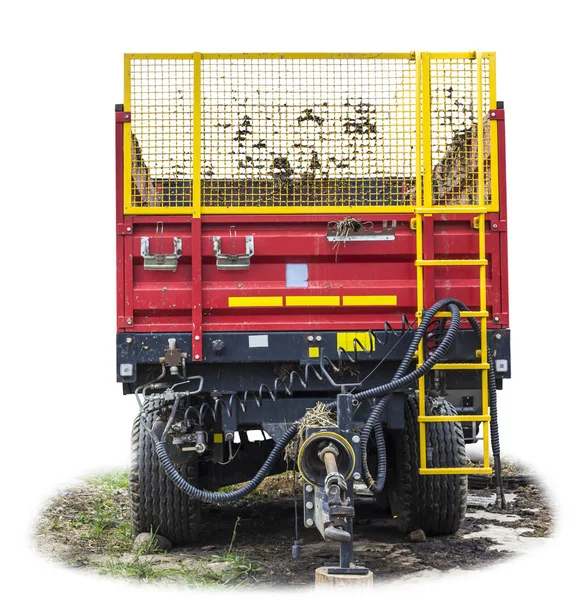 Agricultural machinery on a farm. Trailer-distributor of fertilizers from manure and straw after working in the field. Isolated view from the front.