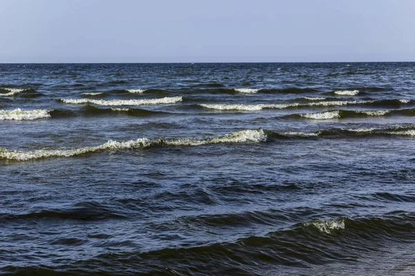 Baltic Sea. Small waves near the beach. Marine background for the site about the sea, nature, romance, love, relaxation, travel.