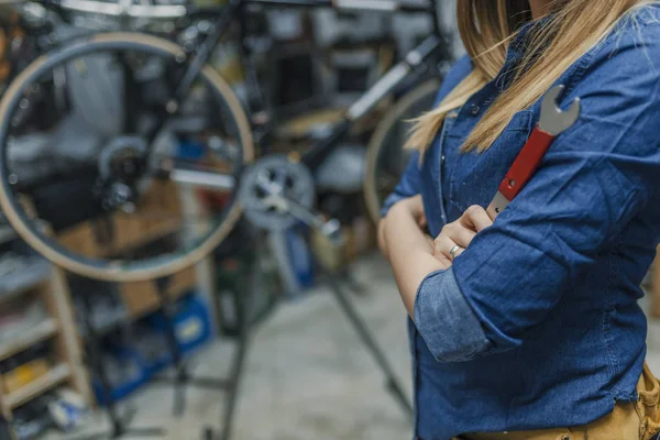 Young woman working in factory. Proud Female Mechanic. Girls can fix things too