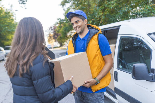 Courier delivering cardboard box to woman