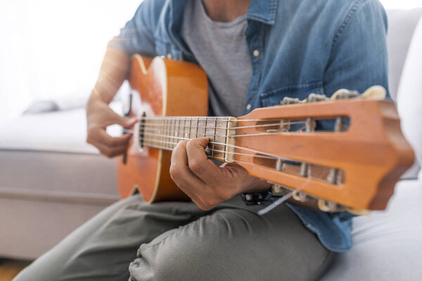 Close up of man playing guitar