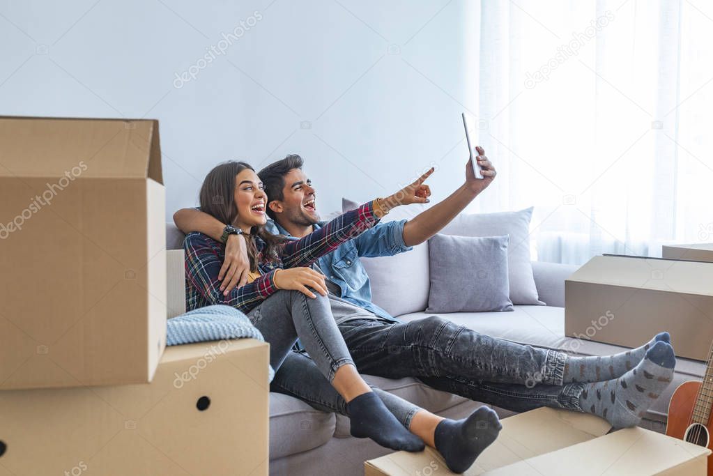 Young couple taking selfie in new home 