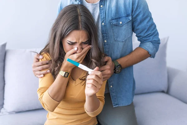 Upset couple after pregnancy test result
