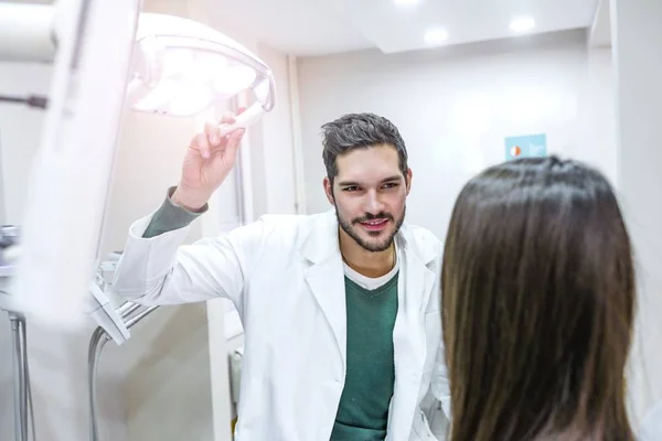 Retrato Dentista Segurando Lâmpada Luz Sobre Paciente Clínica Odontológica — Fotografia de Stock