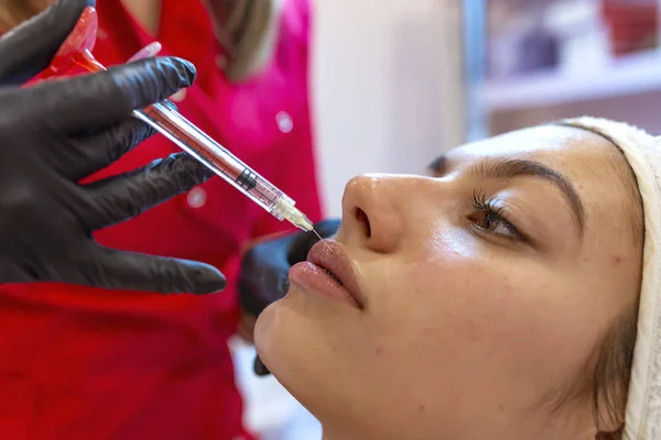 Close up of lips filler injection procedure