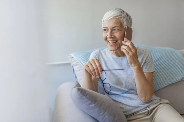 Mature Woman Sitting Sofa Home Smartphone — Stock Photo, Image