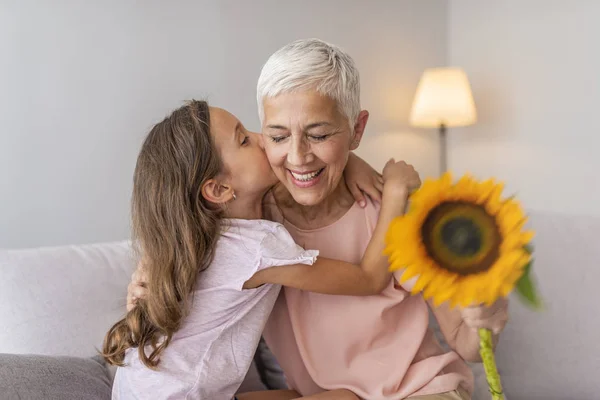 Happy Grandmother Hugging Small Cute Grandchild Thanking Flowers Presented Excited — Stock Photo, Image