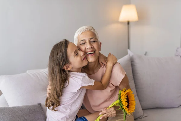 Happy Grandmother Hugging Small Cute Grandchild Thanking Flowers Presented Excited — Stock Photo, Image