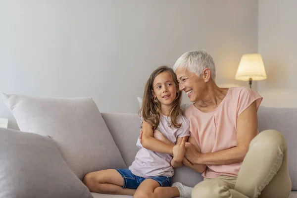 Grandmother Her Cute Granddaughter Granddaughter Kissing Grandmother Cheek Living Room — Stock Photo, Image