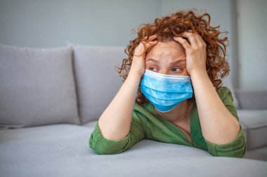 Young woman in medical mask stay isolation at home for self quarantine. Concept home quarantine, prevention COVID-19, Coronavirus outbreak situation. Woman wear with protective face mask at home. clipart