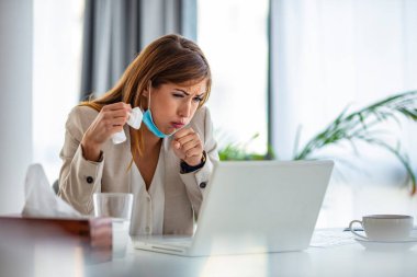 Cropped shot of an attractive young businesswoman sitting alone in her office and coughing as she suffers from a cold. Medical mask and hand disinfectant and stressed woman. Cropped shot of a businesswoman working in her office while suffering from a clipart