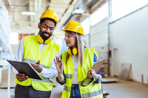 two  architect working with clipboards at construction site
