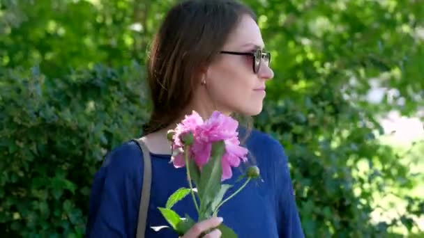 Jeune femme avec fleur de pivoine — Video