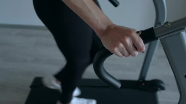 Attractive girl running at home on a treadmill — Stock Video