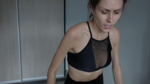 Attractive girl running at home on a treadmill — Stock Video