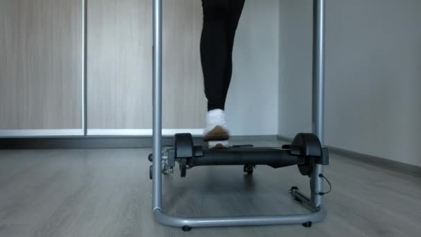 Female foots running on treadmill at home — Stock Video